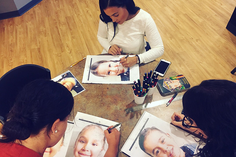 FVM employees tracing children's photos for the Memory Project
